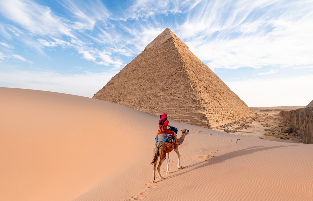 camels,in,giza,pyramid,complex, ,a,woman,in,a